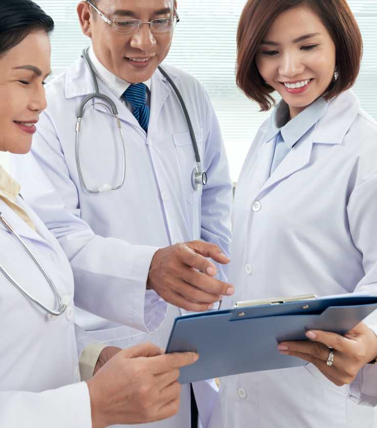image of a group of doctors looking at a paper